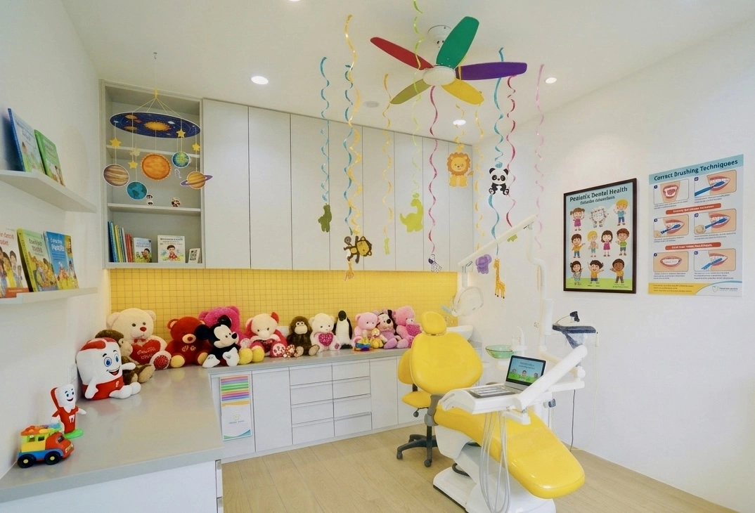 Child-friendly yellow dental room with toys at Bhai-Bhai Dental Clinic